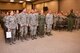 Vice commander of the 932nd Airlift Wing, Col. Esteban L. “Esty” Ramirez (at far right in flight suit) leads the applause for those newly graduating from the CCAF program.  The 932nd Education Office recently held a graduation event and presented a Community College of the Air Force graduation certificate to various 932nd Airlift Wing Airmen, seen here on the first two rows, during a special weekend ceremony held on December 6, 2016 at the Illinois Air Force Reserve Command unit located at Scott Air Force Base, Ill.  This was the 2016 graduating CCAF class, the first official graduation ceremony, (U.S. Air Force photo by Tech. Sgt. Christopher Parr)