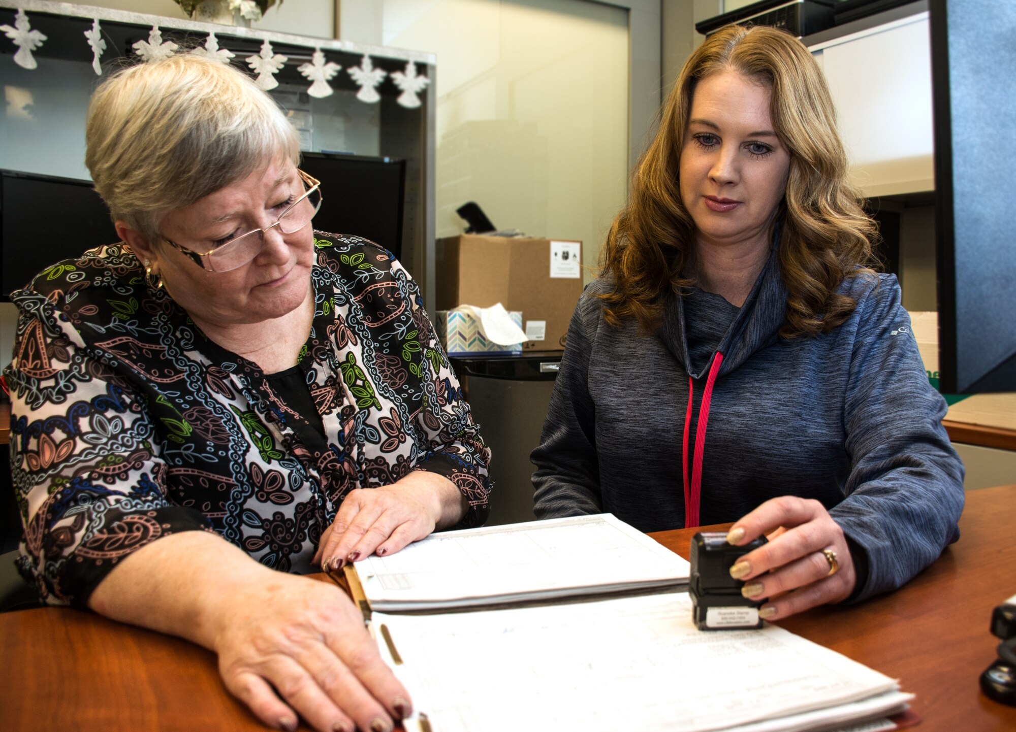 Flo Adams and Nicole Bline, 312th Airlift Squadron aviation resource managers, review mission packages to check currancies and ensure data is accurate at Travis Air Force Base, Calif., on Dec. 28, 2016. The 312th AS is part of the 349th Air Mobility Wing. The 349th Operations Group ARMS team won Large ARMS Unit of the Year for Air Force Reserve Command. (U.S. Air Force photo/Staff Sgt. Daniel Phelps)