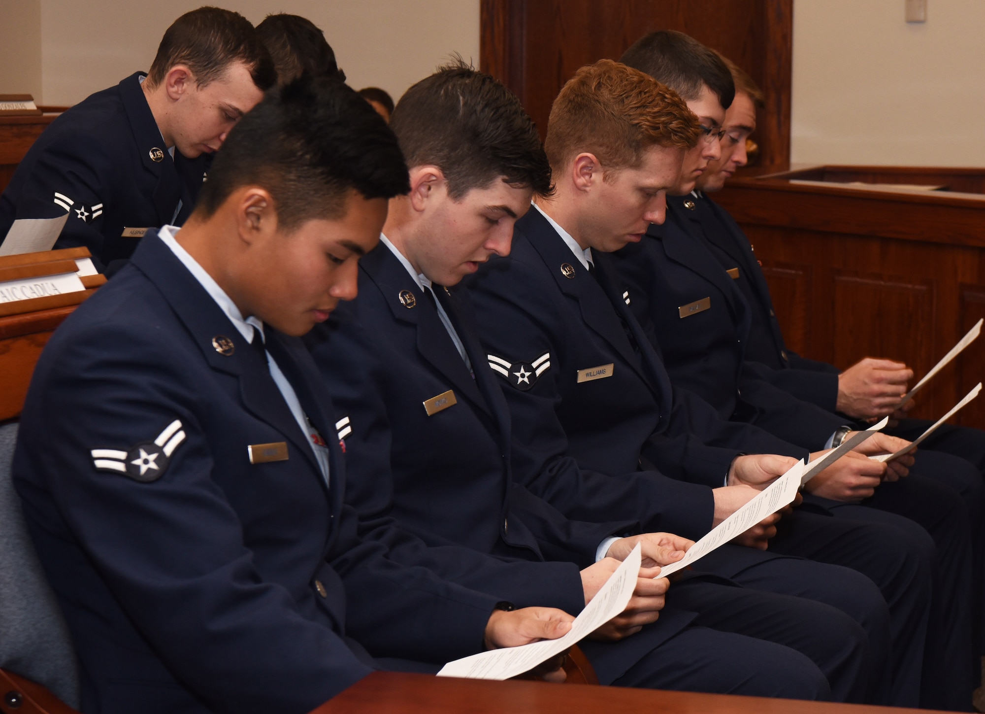 Members of the jury peruse the details of the case during a mock trial at F.E. Warren Air Force Base, Wyo., Dec. 16, 2016. The trial allowed first term Airmen to see how a real trial works. The legal office recently initiated this program for first term Airmen to demonstrate the consequences of sexual assault from various perspectives. (U.S. Air Force photo by Airman 1st Class Breanna Carter)