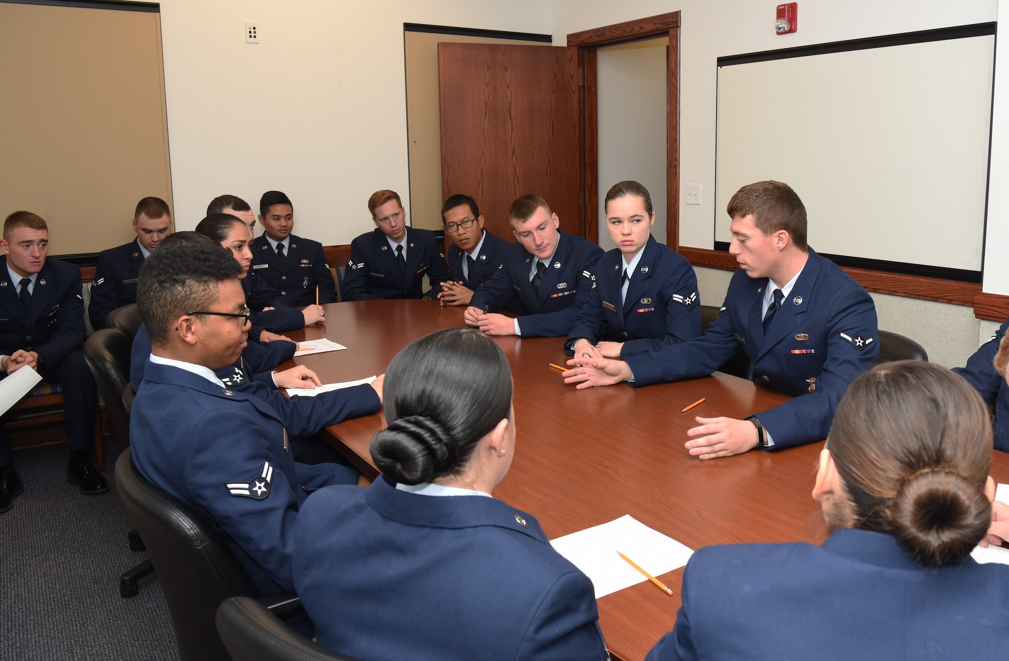 The jury discusses the evidence to reach a verdict during the mock trial at F.E. Warren Air Force Base, Wyo., Dec. 16, 2016.  The first term Airmen were asked to assess the evidence and testimonies and come to a unanimous decision. The legal office recently initiated this program for first term Airmen to demonstrate the consequences of sexual assault from various perspectives. (U.S. Air Force photo by Airman 1st Class Breanna Carter)