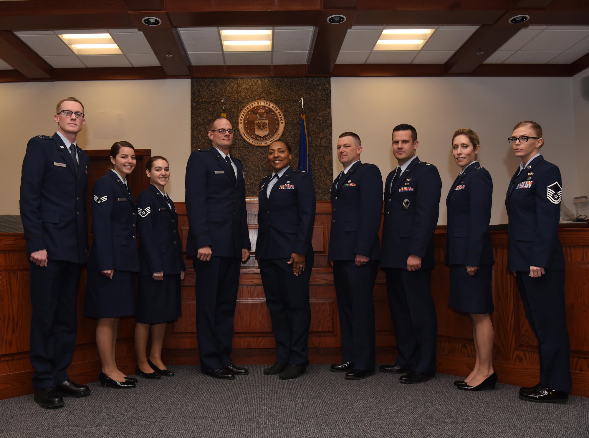 The 90th Missile Wing legal office staff stands in front of the judge’s seat in the courtroom at F.E. Warren Air Force Base, Wyo., Dec. 16, 2016. The office recently initiated a program for first term Airmen called “Got Consent” which is designed to confront participants with the consequences of sexual assault from various perspectives. (U.S. Air Force photo by Airman 1st Class Breanna Carter)