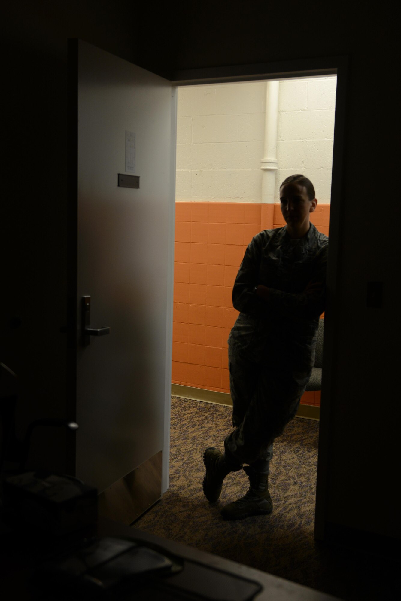 Technical Sgt. Jessica Tabor, 673d Equal Opportunity noncommissioned officer in charge, looks inside her late supervisor’s room at Joint Base Elmendorf-Richardson, Alaska, Dec. 29, 2016. About six months ago, EO lost their superintendent and the office is still recovering; the room remains unoccupied. 