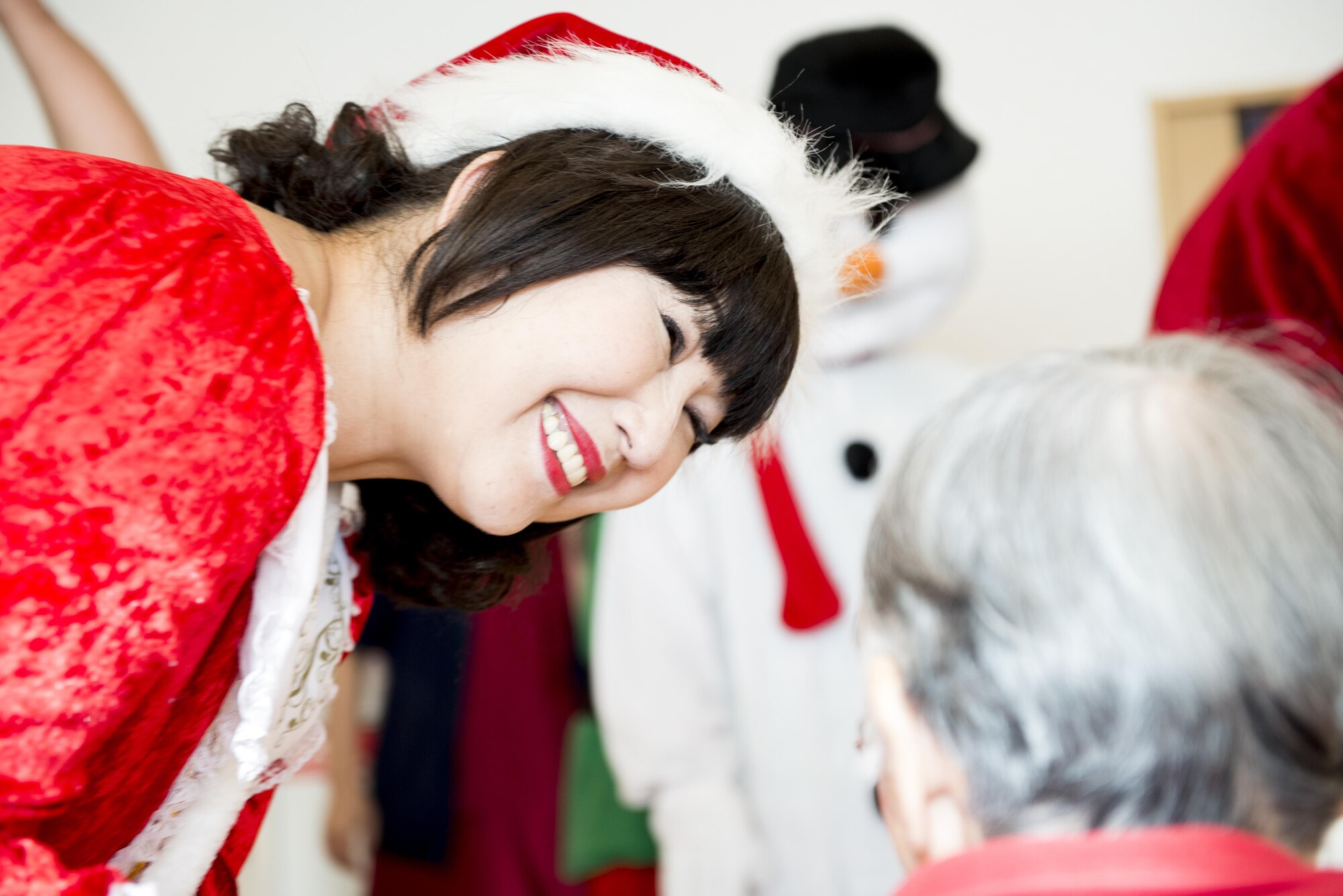 Miss Claus visits with a resident of the Fussa Kotobuki Garden Nursing Home during a Christmas Eve visit on Dec. 24, 2016, in Fussa, Tokyo, Japan. Volunteers from Yokota Air Base’s Community Center Outreach Program have been visiting the Fussa Kotobuki Garden Nursing Home since 2013. (U.S. Air Force photo by Airman 1st Class Donald Hudson)