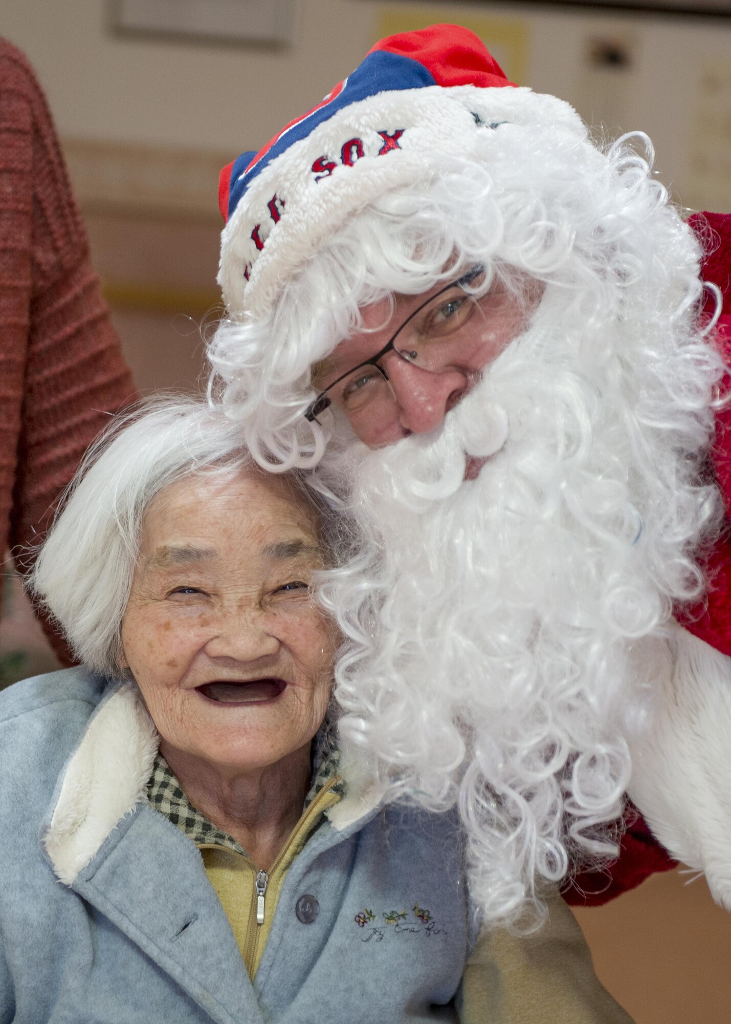 Richard H. King Yokota Air Base Community Centers Assistant Director, dressed as Santa Claus, poses for a photo with a resident of the Fussa Kotobuki Garden Nursing Home during a Christmas Eve visit on Dec. 24, 2016, in Fussa, Tokyo, Japan. Volunteers from Yokota Air Base’s Community Center Outreach Program visit the Kotobuki Garden Nursing Home multiple times a year to visit with the residents to provide positive and caring outreach opportunities in the local community. (U.S. Air Force photo by Airman 1st Class Donald Hudson)