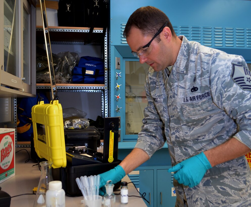 Master Sgt. Joe Runewicz, 111th Medical Group noncommissioned officer in charge of bioenvironmental engineering and occupational environmental health manager, illustrates the use of a machine to test solid samples at the 111th Attack Wing Medical Clinic, Horsham Air Guard Station, Pa., Dec. 22, 2016. The bioenvironmental engineering career field include various responsibilities, from the fetal protection program to occupational health hazard prevention. (U.S. Air National Guard photo by Tech. Sgt. Andria Allmond/Released)