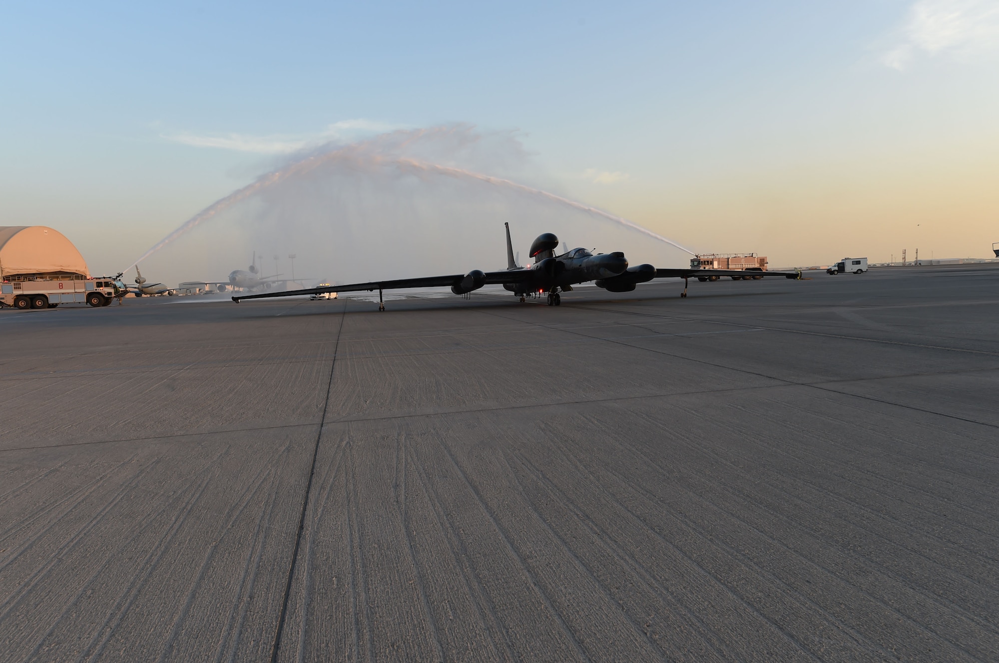 A U-2, flying from the 380th Air Expeditionary Wing at an undisclosed location in Southwest Asia, approaches the maintenance hangar after the final sortie for one of its mission systems, Dec. 15, 2016. The final flight is celebrated with a traditional shower and a greeting party consisting of the crews that have maintained the now retired mission system. The retired system will be replaced with one that is currently flown on the RQ-4, enhancing the combined products of manned and unmanned high-altitude products.  (U.S. Air Force photo by Tech. Sgt. Christopher Carwile)