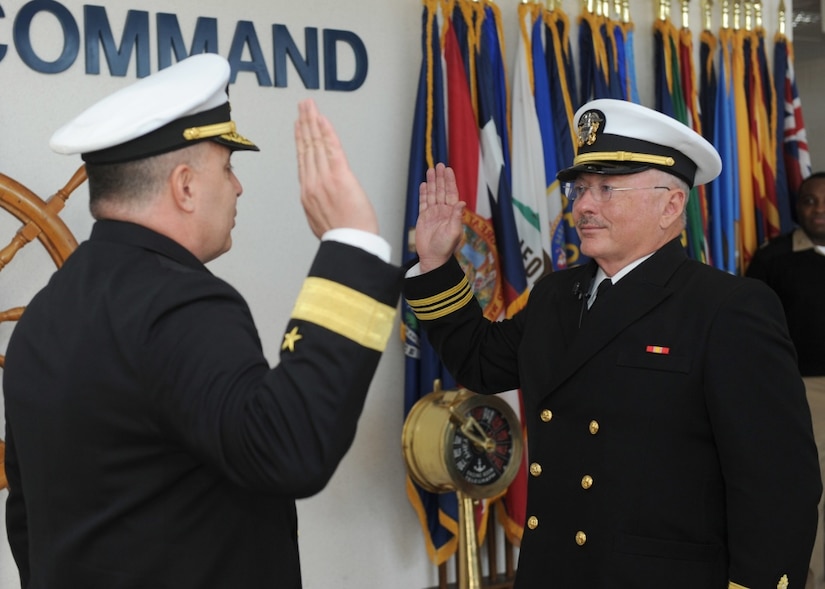 Navy Rear Adm. Doug Beal, deputy commander of Navy Recruiting Command, left, delivers the oath of commissioning to Dr. Charles Wallace in Millington, Tenn., Dec. 19, 2016. Navy photo by Petty Officer 3rd Class Brandon Martin