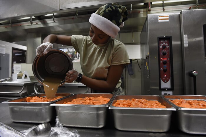 U.S. Air Force Airman 1st Class Adaigah Rouse Lewis, 628th Force Support Squadron dining facility shift leader, prepares carrots for Christmas dinner at the Gaylor Dining Facility Dec. 25, 2016. The dining facility began preparing for the Christmas dinner during the Thanksgiving holiday.