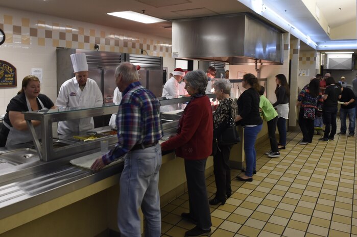 Joint Base Charleston leadership and their families serve Christmas dinner to Airmen, retirees and their families at the Gaylor Dining Facility, Dec. 25, 2016. Members of the dining facility began cooking and prepping the main courses on Dec. 24 and did not finish until early Dec. 25.