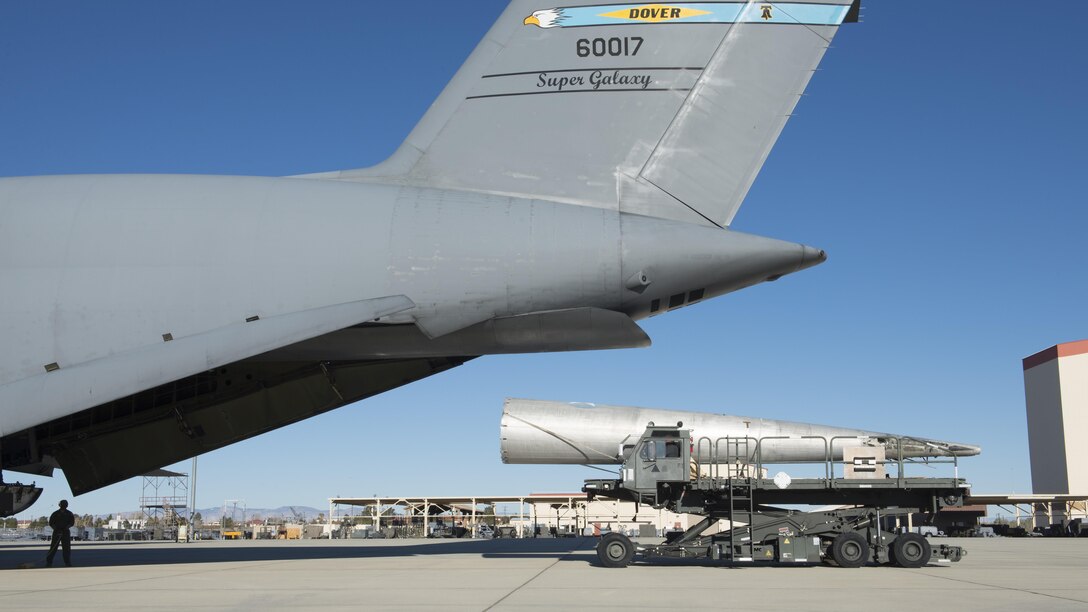 A tail-boom from the Fairchild C-119B Flying Boxcar #48-0352 “Am Can Co Special” is loaded into a C-5M Super Galaxy Dec. 19, 2016, at Edwards Air Force Base, Calif. This C-119 airdropped mobile bridge sections during the Battle of Chosin Reservoir during the Korean War. (U.S. Air Force photo by Senior Airman Zachary Cacicia)