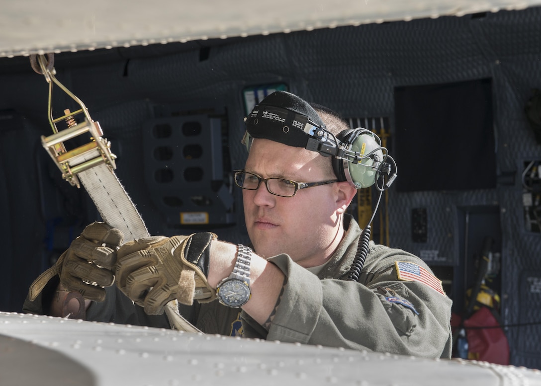 Master Sgt. Bryan Muise, 709th Airlift Squadron loadmaster, straps down the wings of the Fairchild C-119B Flying Boxcar #48-0352 “Am Can Co Special” inside a C-5M Super Galaxy Dec. 19, 2016, at Edwards Air Force Base, Calif. This C-119 was destined to be sold for scrap metal had it not been rescued by the Air Mobility Command Museum. (U.S. Air Force photo by Senior Airman Zachary Cacicia)