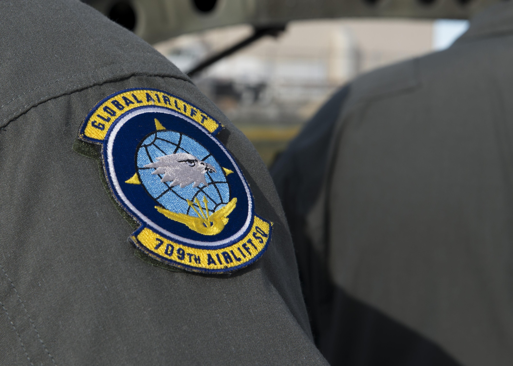 A 709th Airlift Squadron patch sits on the shoulder of Master Sgt. Paul Adkins, 709th AS loadmaster, during a mission to bring the Fairchild C-119B Flying Boxcar #48-0352 “Am Can Co Special” to the Air Mobility Command Museum via a C-5M Super Galaxy airlifter Dec. 16, 2016, at Edwards Air Force Base, Calif. The 709th AS is a component of the 512th Airlift Wing, a Reserve unit stationed at Dover AFB, Del. (U.S. Air Force photo by Senior Airman Zachary Cacicia)