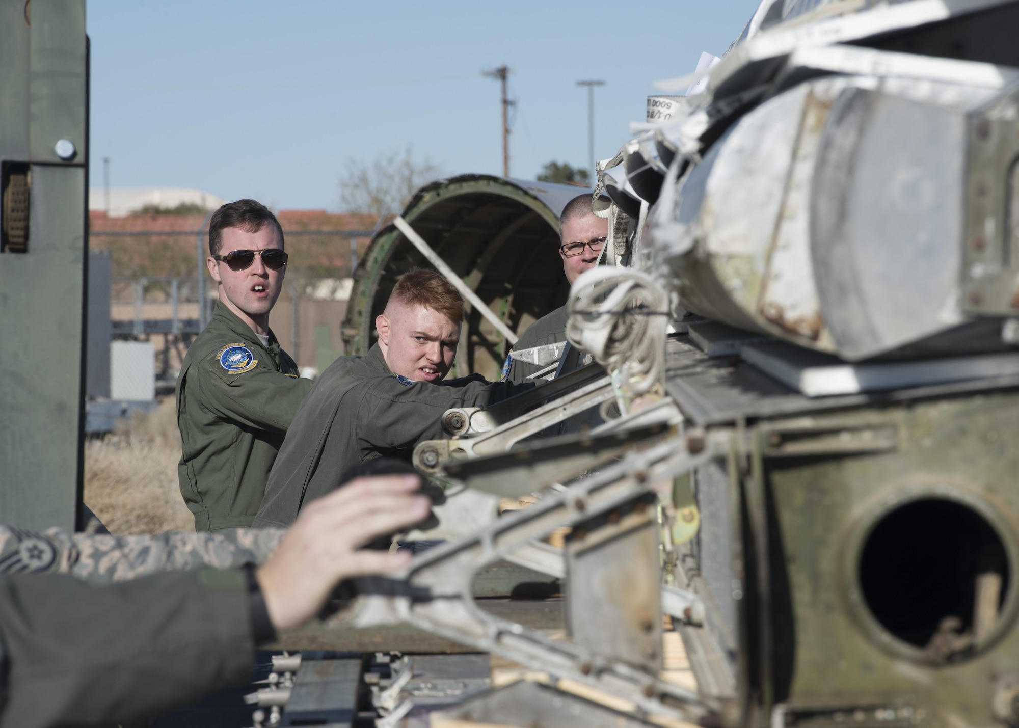 Loadmasters from the 709th Airlift Squadron load portions of the Fairchild C-119B Flying Boxcar #48-0352 “Am Can Co Special” onto a K-Loader during a mission to bring it to the Air Mobility Command Museum via a C-5M Super Galaxy airlifter Dec. 17, 2016, at Edwards Air Force Base, Calif. The C-119 was a military transport aircraft used primarily to carry cargo, personnel and equipment. It also had airdrop capabilities. (U.S. Air Force photo by Senior Airman Zachary Cacicia)