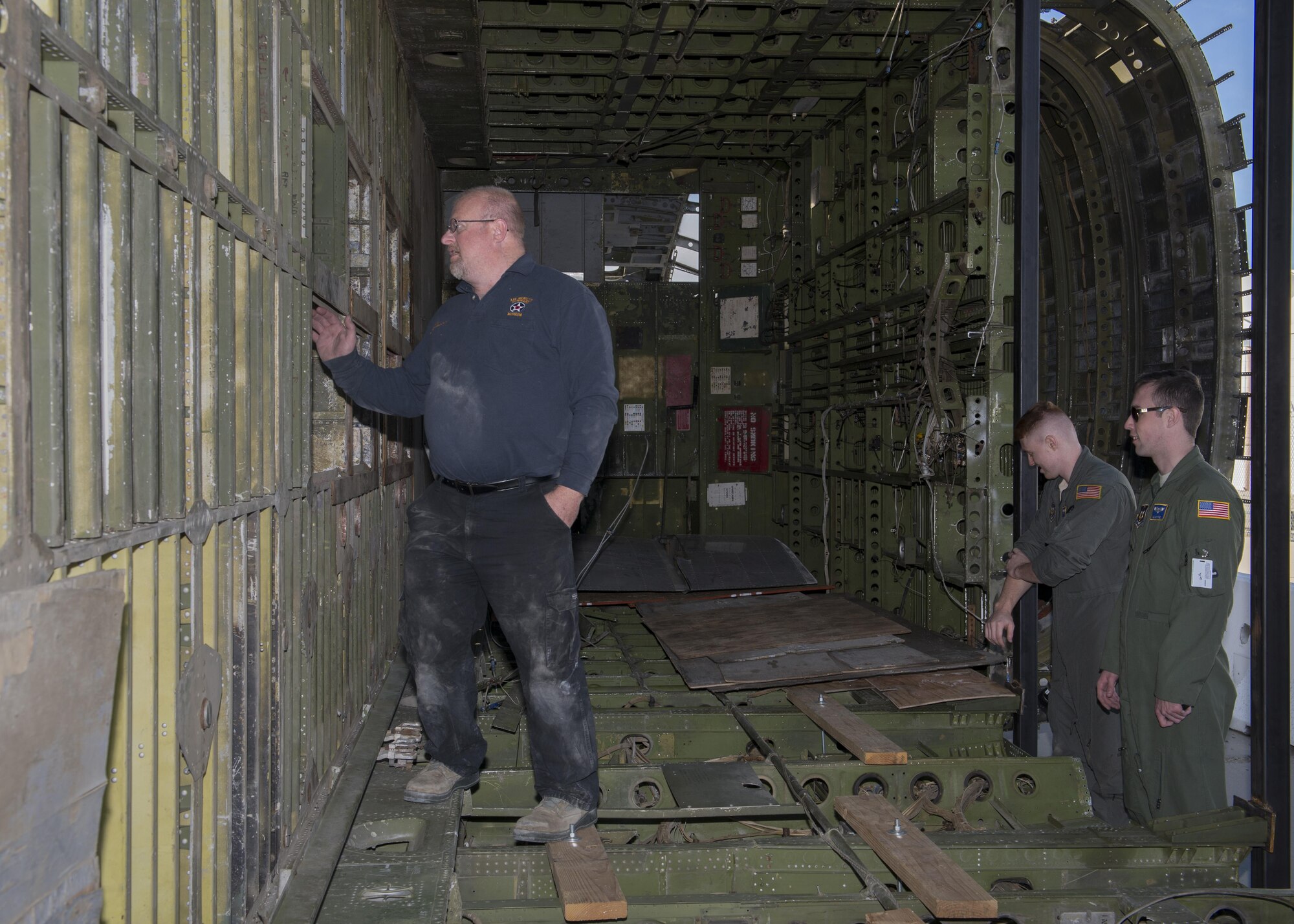 Les Polley, Air Mobility Command Museum aircraft restoration chief, inspects the interior fuselage of the Fairchild C-119B Flying Boxcar #48-0352 “Am Can Co Special” during a mission to bring it to the AMC Museum via a C-5M Super Galaxy airlifter Dec. 17, 2016, at Edwards Air Force Base, Calif. A full restoration will take place on the C-119 once it arrives at the AMC Museum. (U.S. Air Force photo by Senior Airman Zachary Cacicia)