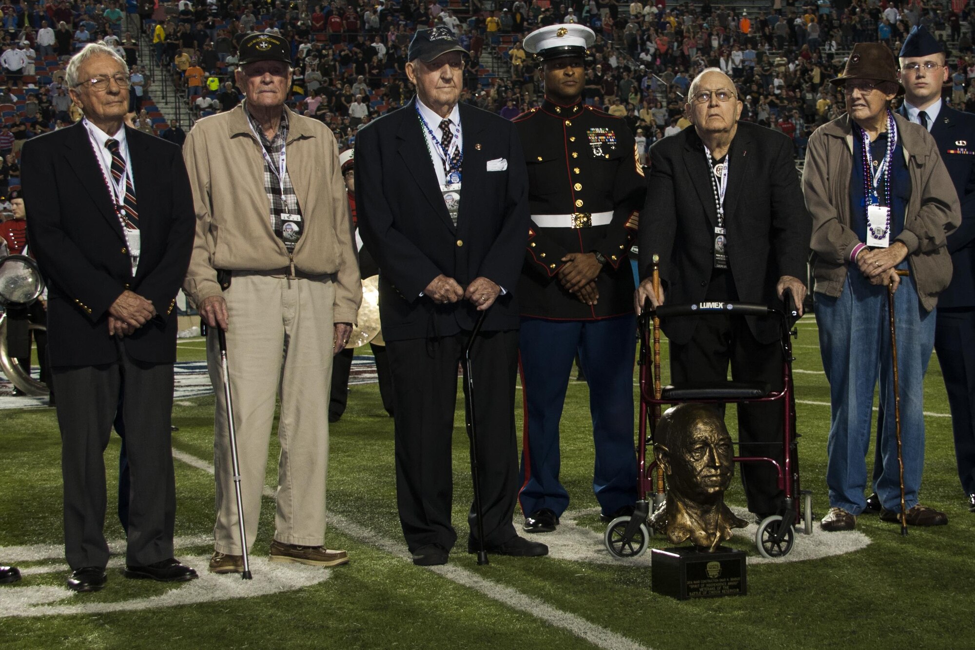 Veterans of the Battle of the Chosin Reservoir enjoy a standing ovation from the crowd at the Camping World Independence Bowl Dec. 26th, 2017 in Shreveport, La.  Members of the 307th Bomb Wing and 2nd Bomb Wing were on hand to congratulate the veterans for receiving the Omar Bradley Spirit of Independence Award.  The Battle of the Chosin Reservoir, fought during the Korean conflict, saw American troops fight off numerically superior enemy forces.  In doing so, they changed the course of the conflict, allowing United Nations troops to keep a foothold on the Korean peninsula.  (U.S. Air Force photo by Tech. Sgt. Ted Daigle/Released) 