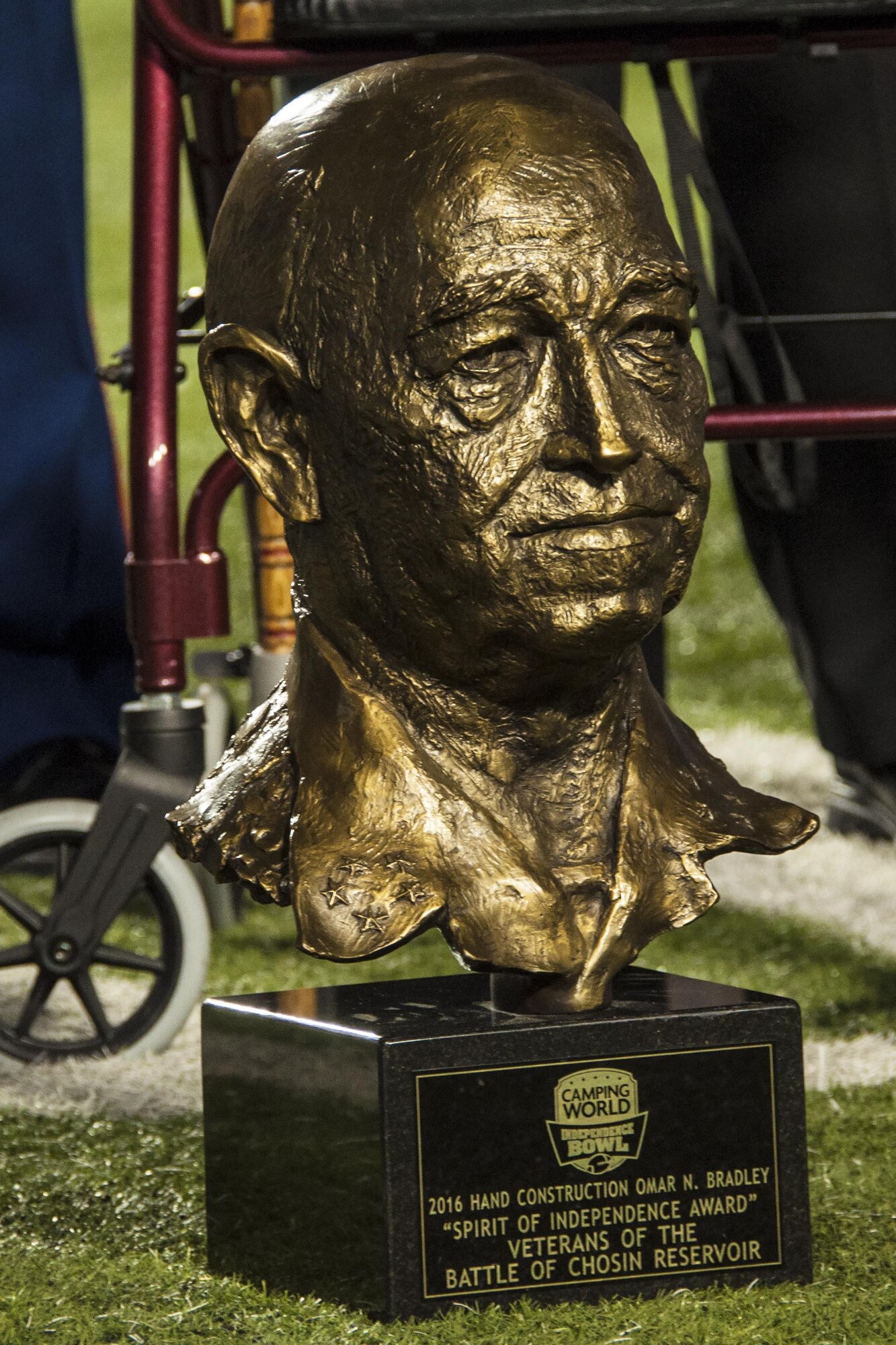 The Omar Bradley Spirit of Independence Award sits in front of the walker of a Battle of Chosin Reservoir Veteran Dec. 26th, 2017 in Shreveport, La.   The battle took place during the Korean conflict more than sixty years ago.  It is widely regarded as a pivotal moment in the fight, helping to keep United Nations and South Korean troops from being overrun by communist forces.   Members of the 307th Bomb Wing and 2nd Bomb Wing were on hand during the ceremony to honor the veterans.  (U.S. Air Force photo by Tech. Sgt. Ted Daigle/Released)