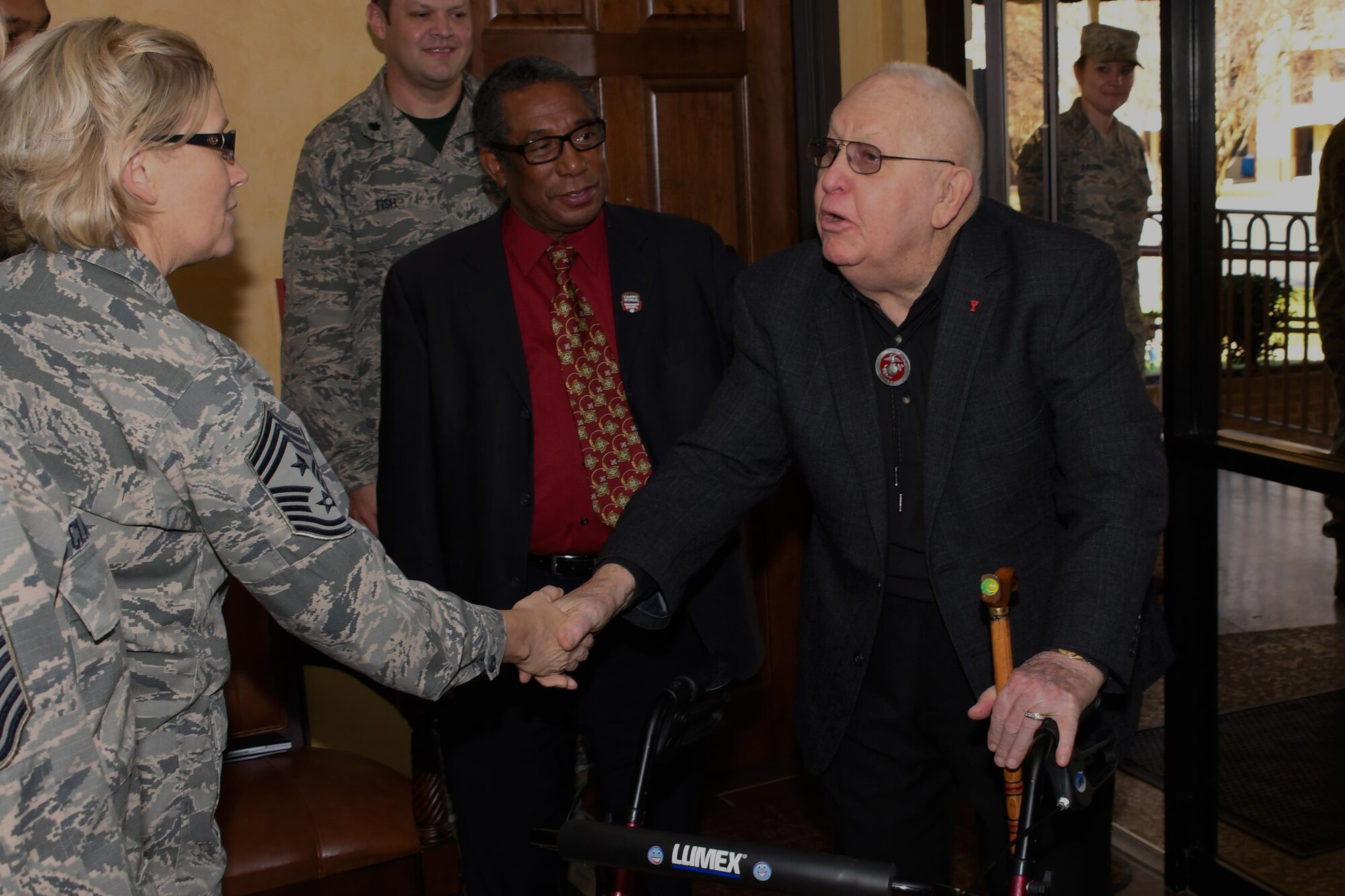 U.S. Air Force Chief Master Sgt. Shelley Cohen, 307th Bomb Wing command chief, greets a veteran of The Battle of Chosin Reservoir Dec. 22, 2016 at Barksdale Air Force Base, La.   Cohen and Col. James Morriss III, 307th BW vice-commander, were on hand at a luncheon honoring the veterans.  The luncheon was part of a week-long slate of events sponsored by the Independence Bowl Foundation to honor the veterans. The Battle of Chosin Reservoir, fought during the Korean conflict, saw vastly outnumbered American troops fight their way to safety against enemy forces through temperatures as low as -34 Fahrenheit. (U.S. Air Force photo by Tech. Sgt. Ted Daigle/Released)