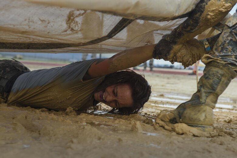 Staff Sgt. Stacey, 799th Air Base Squadron personalist performs the low crawl portion of the Life of a Warrior Challenge May 20, 2016 at Creech Air Force Base, Nevada. The SFS Airmen, local highway patrol officers and Las Vegas Police Department gathered together during National Police Week at Creech AFB for a law enforcement fitness challenge honoring those who have served in law enforcement. (U.S. Air Force photo by Senior Airman Adarius Petty /Released)