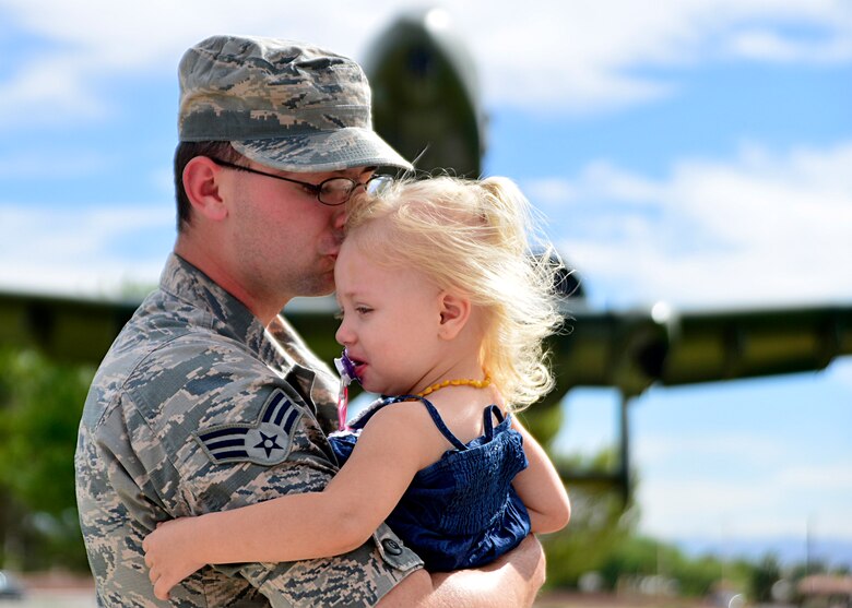 Senior Airman Christian, 432nd Wing/432nd Air Expeditionary Wing photojournalist and daughter Francesca, 2, share in a kiss at Nellis Air Force Base, Nevada, June 9, 2016. Christian, who grew up as a military child, reflects on his transition to from military child to military father. “On this Father’s Day I like to say: to the fallen, you’re legacy lives on, to those who are in harm’s way, stay safe, to those who served, thank you. To military dads everywhere, I salute you.” (U.S. Air Force Photo by Tech. Sgt. Nadine Barclay)