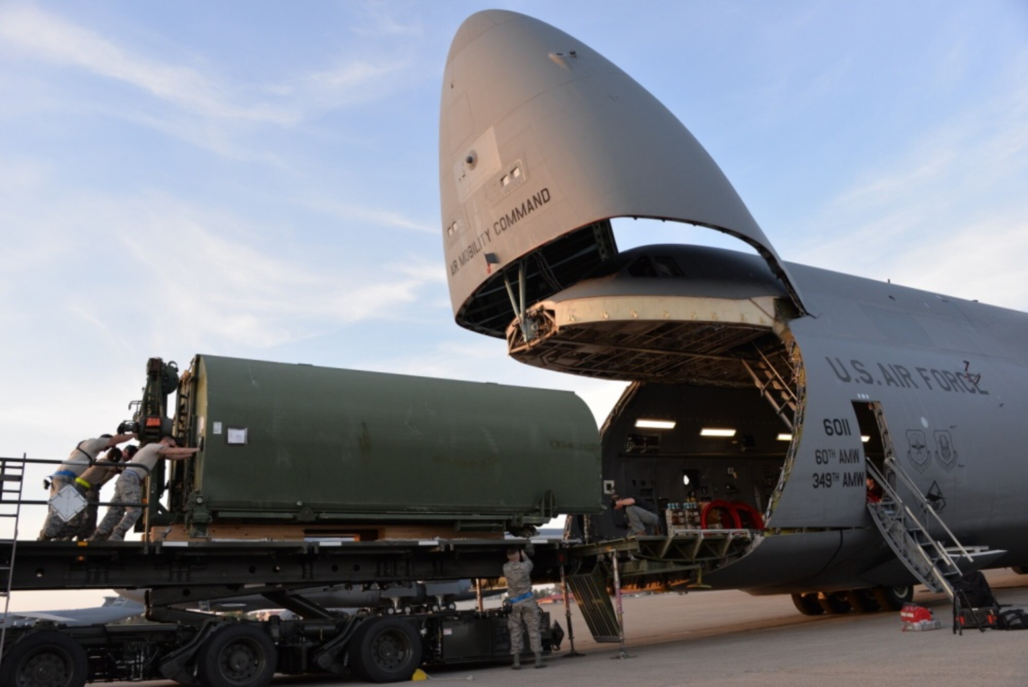 Airmen from the 60th Aerial Port Squadron load a C-5M Super Galaxy with essential cargo and an Improved Ribbon Bridge, May 12, 2016, at Travis Air Force Base, Calif. The bridge and cargo were flown to Iraq by the 22nd Airlift Squadron and directly contributed to the counter-Islamic State of Iraq and the Levant campaign during Operation Inherent Resolve in Mosul, Iraq. (U.S. Air Force photos by Senior Airman Amber Carter)