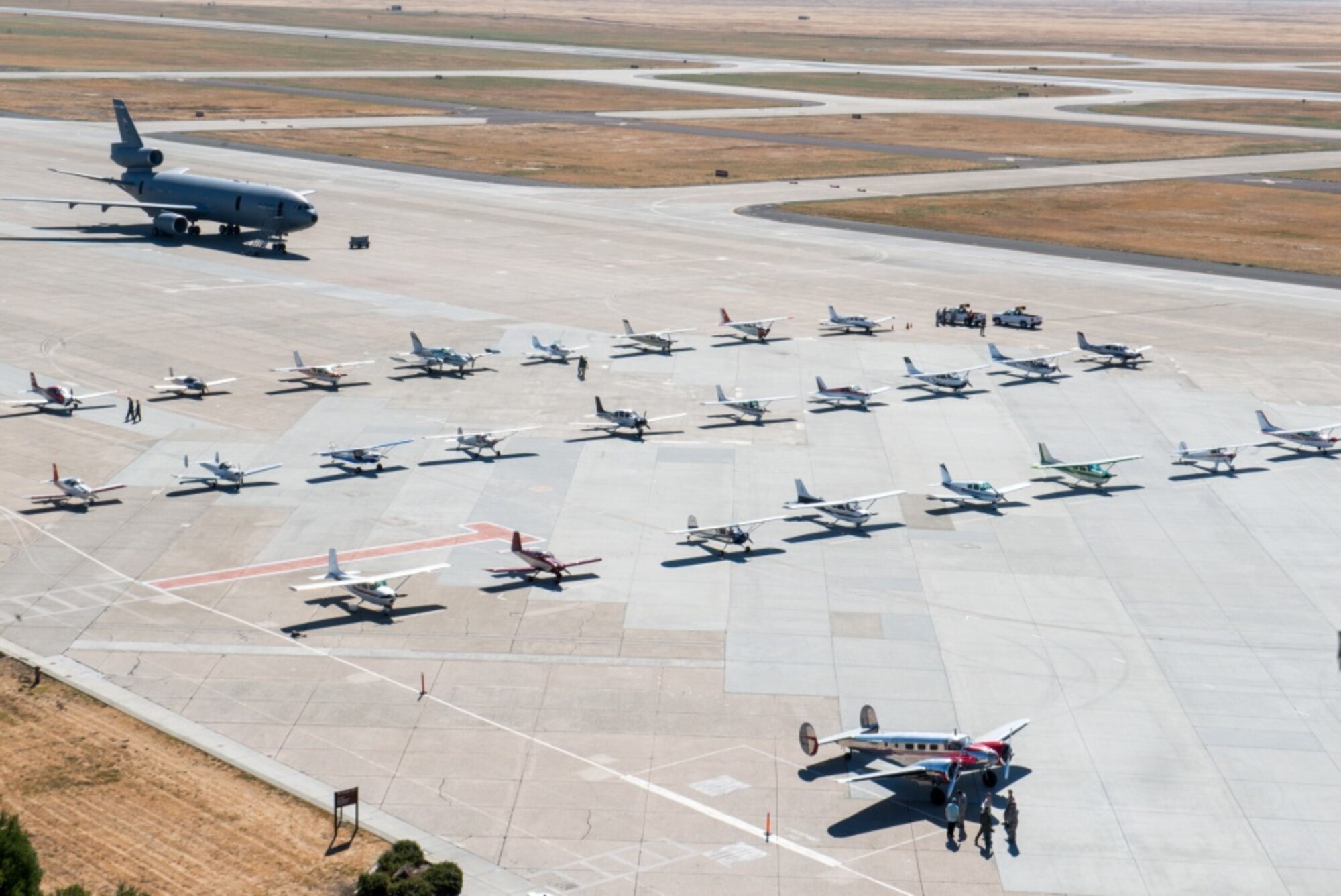 Civilian aircraft are parked on the tarmac at Travis Air Force Base, Calif. Local pilots were invited to attend the Travis Air Force Base Mid-Air Collision Avoidance (MACA) fly-in event. The purpose of the event is to promote safe air operations and strengthen the relationship with civil aviation pilots who frequently transit in and around Travis Air Force Base airspace. The 60th Air Mobility Wing safety office provided more than 35 pilots and 70 guests with a full day of activities to include a tour of air traffic control tower, C-5M Super Galaxy, and a KC-10 Extender, Jun. 25, 2016. (U.S. Air Force photo by Louis Briscese/Released)