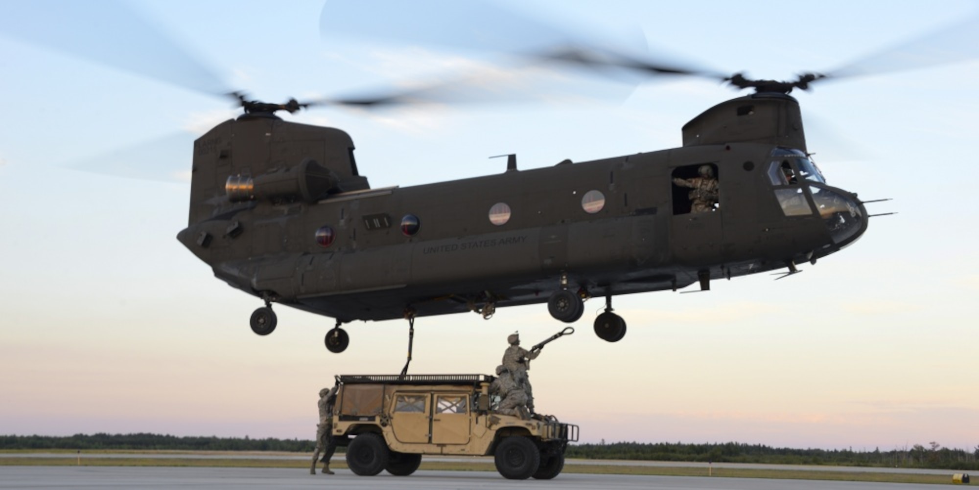 Airmen from the 821st Contingency Response Group out of Travis Air Force Base, California, get positioned to attach a HUMVEE to a U.S. Army CH-47 Chinook Aug. 9, 2016, at the Alpena Combat Readiness Training Center, Michigan, during Exercise Northern Strike. Exercise Northern Strike is a joint force exercise that combines the total force concept including Air Force, Army and Marines from various states and countries. (U.S. Air Force photo by Senior Airman Amber Carter)