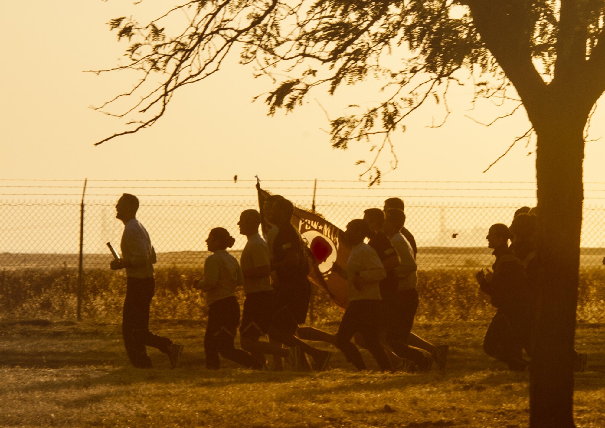As the sun rises, 60th Air Mobility Wing Airmen from Wing Staff Agencies, run on blue track with a Prisoner of War/Missing in Action batons Sept. 16, 2016, at Travis Air Force Base, Calif. The run honors the nation’s former prisoners of war and those service members who are still missing in action. Travis participants will carry a pair of batons continuously around the track in 15-minute shifts ending Friday afternoon with a ceremony held at the 60 AMW Headquarters. The POW/MIA baton carries a flash drive that contains all known names of all the accounted for POW/MIAs since WWI. At present, more than 83,000 Americans remain missing from WWII, the Korean War, the Vietnam War, the Cold War, and the Gulf Wars/other conflicts.(U.S. Air Force Photo by Heide Couch)