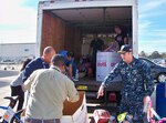 DLA Aviation at Jacksonville, Florida, Navy Commander Daniel Bessman, along with other DLA Aviation employees load boxes of toys and bicycles for the annual Toys for Tots Program Dec. 15, 2016.  DLA employees, along with Navy employees from Fleet Readiness Center Southeast’s Avionics Shop, collected and donated six boxes of toys and 10 bicycles, which were given to families in need in the Greater Jacksonville area. 