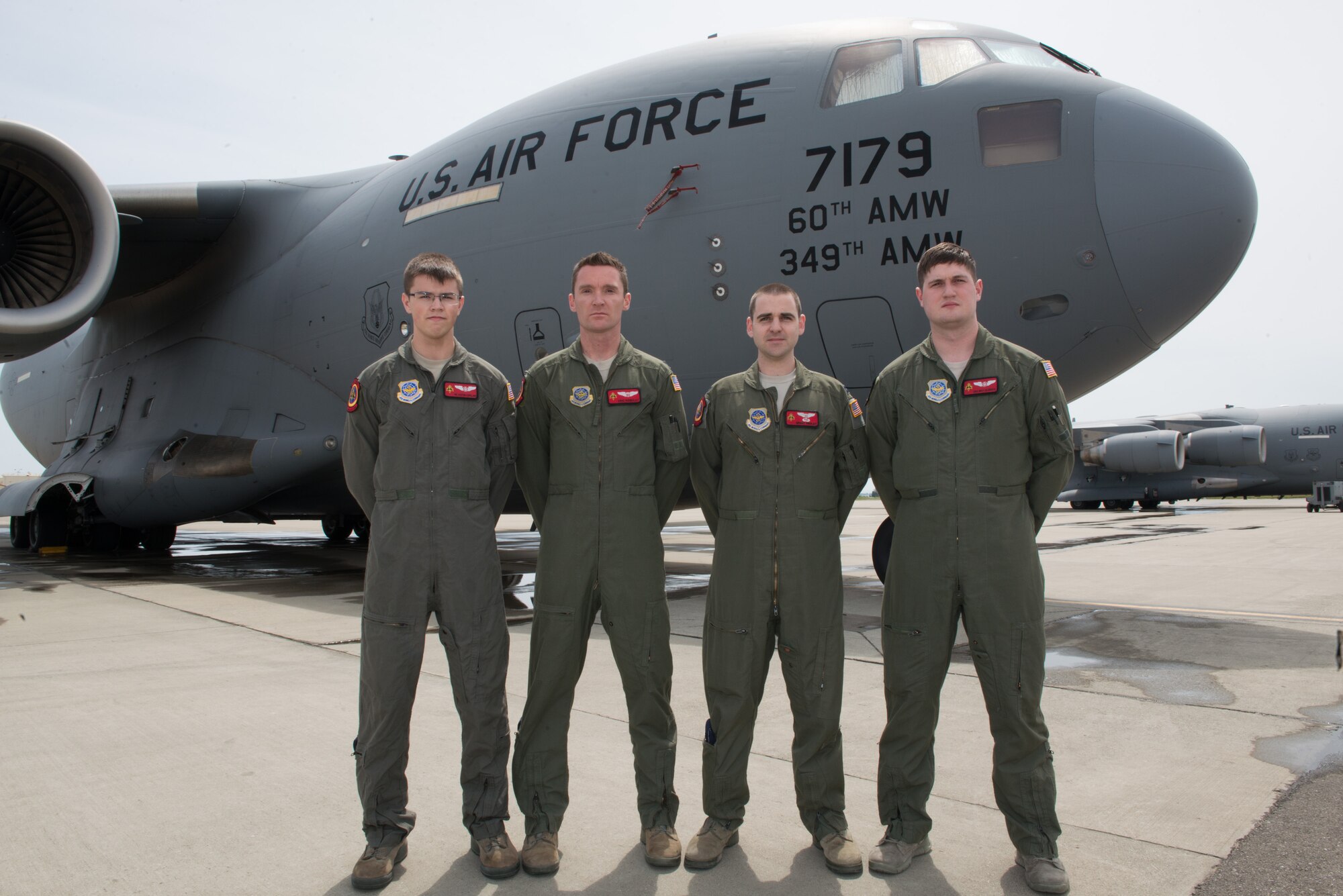 From left, U.S. Air Force Airman 1st Class Austen Copeland, Capt. Eric Rieboldt, Capt. Grant Hadley, and Senior Airman Max Oldroyd, assigned to the 21st Airlift Squadron, Travis Air Force Base, Calif., pose for a group picture on the flight line in front of a C-17 Globemaster III. The aircrew evacuated injured Americans from the terrorist attacks in Brussels, Belgium, not pictured are U.S. Air Force 1st Lt. Justin Gross and Staff Sgt. Chase Decker, April 26, 2016 (U.S. Air Force photo by Louis Briscese/Released)