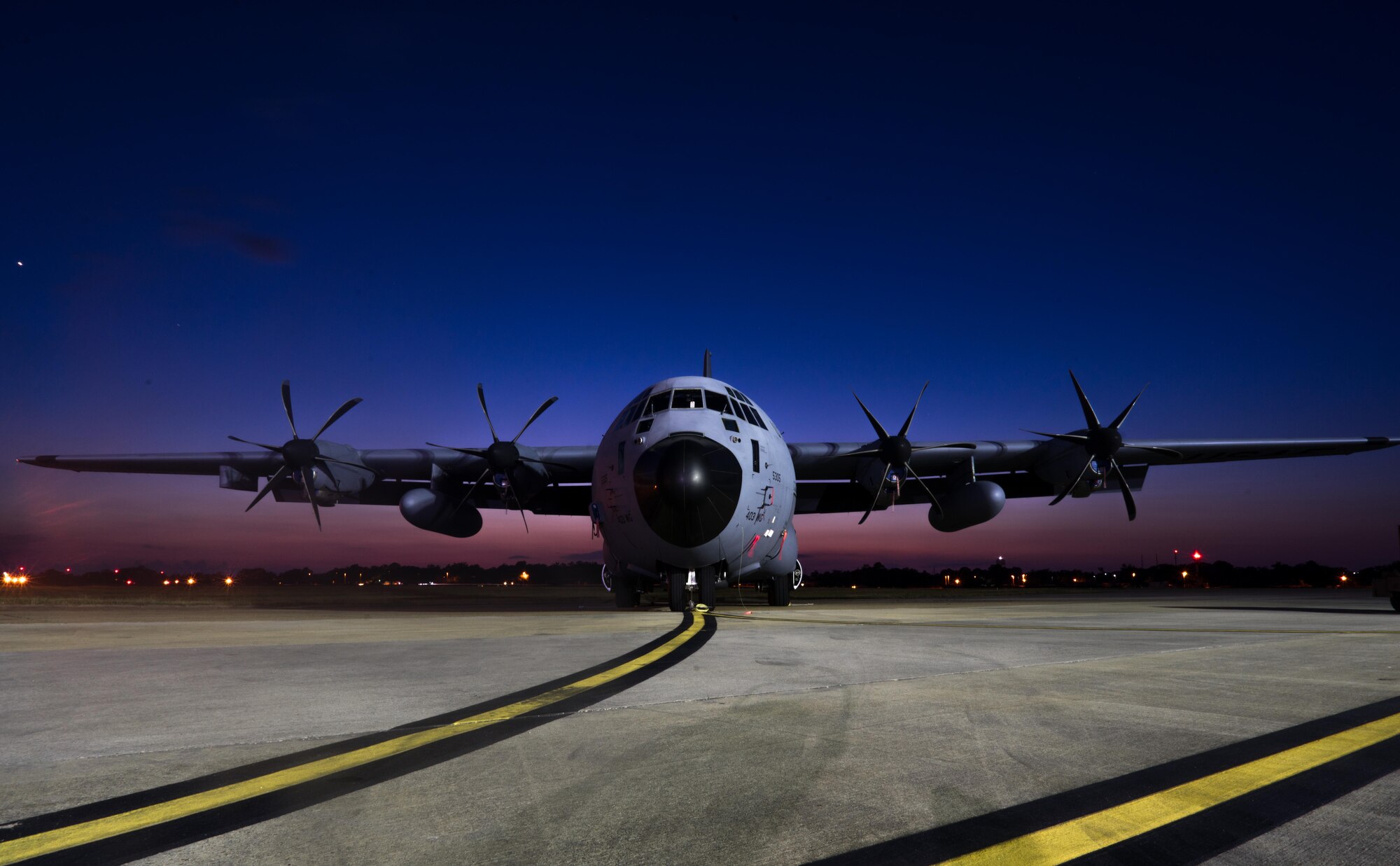 A 403rd Wing WC-130J Super Hercules aircraft is parked on the Keesler Air Force Base flight line as the sun sets. (U.S. Air Force photo/Staff Sgt. Shelton Sherrill)