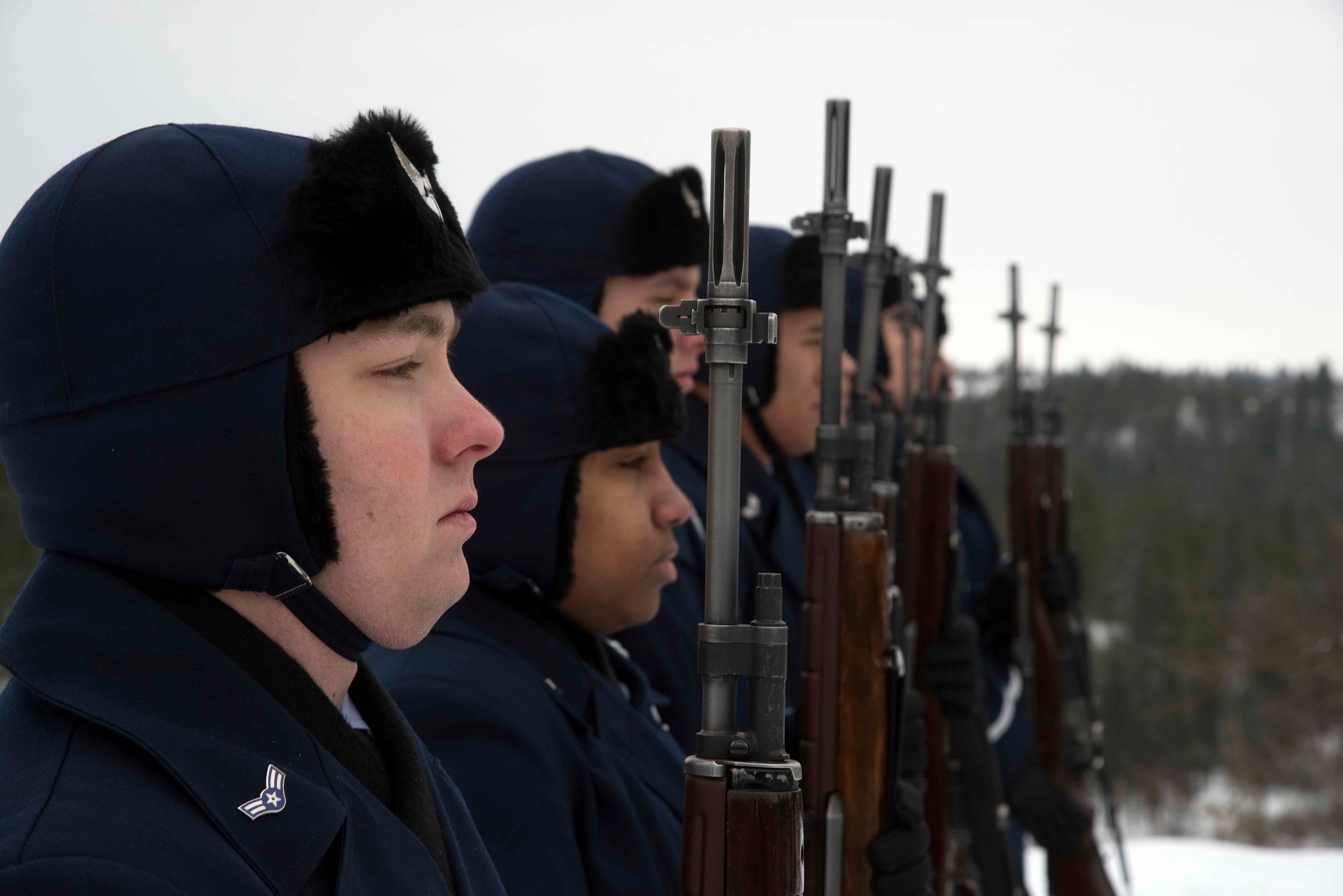 Fairchild ceremonial guardsmen present arms Dec. 19, 2016, at Fort George Wright Cemetery, Spokane, Washington. Honor Guard details perform various functions for the base and local community but their primary mission is to provide funeral honors for deceased military members. (U.S. Air Force photo/Senior Airman Nick J. Daniello)