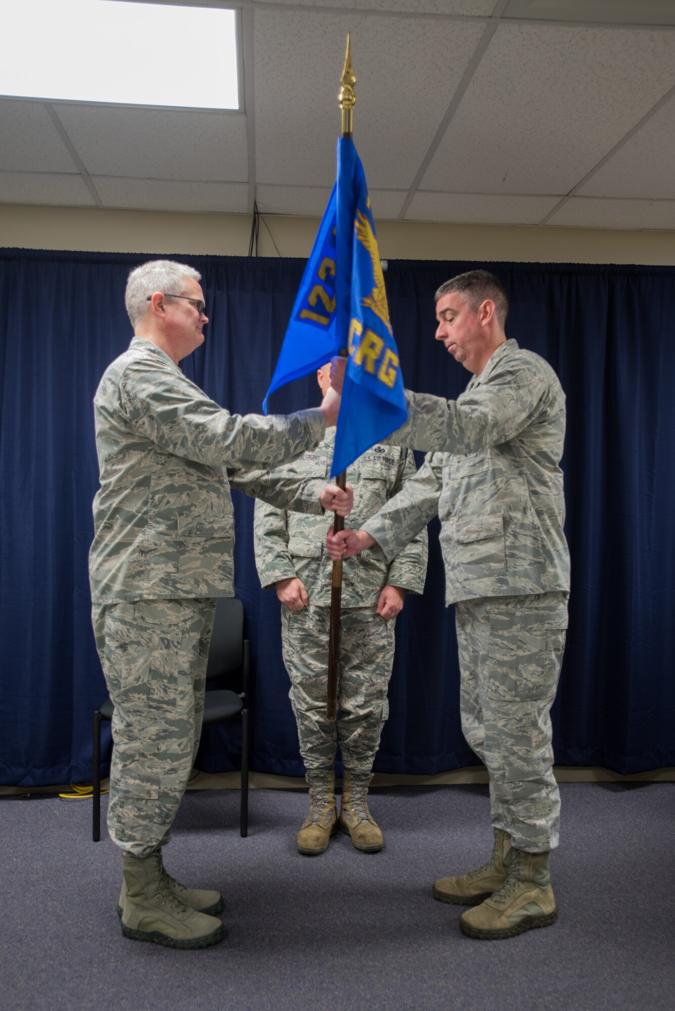 Lt. Col. Bruce Bancroft (right), the new commander of the 123rd Contingency Response Group, accepts the group’s guidon from Col. David Mounkes, wing commander of the 123rd Airlift Wing, during a ceremony at the Kentucky Air National Guard base in Louisville, Ky., on Nov. 5, 2016. (U.S. Air National Guard photo by Tech. Sgt. Vicky Spesard)
