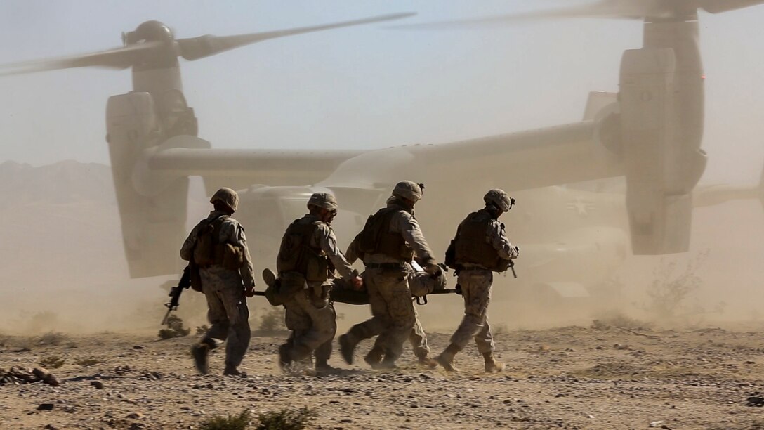 Marines carry a simulated casualty onto an MV-22 Osprey aircraft during urban warfare training on Marine Corps Air Ground Combat Center Twentynine Palms, Calif., Jan. 26, 2016. Marine Corps photo by Cpl. Danielle Rodrigues