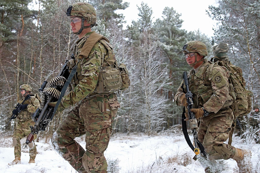 Army Pfc. Kyle Narveson, left, and Army Spc. Rogelio Cardenas move to cover during a live-fire exercise in Konotop, Poland, Jan. 18, 2016. Narveson and Cardenas are infantrymen assigned to the 3rd Squadron, 2nd Cavalry Regiment. The soldiers conducted the squad-level training alongside Polish allies in support of Operation Atlantic Resolve, a multinational demonstration of continued U.S. commitment to the collective security of North Atlantic Treaty Organization allies. Army photo by Sgt. Paige Behringer