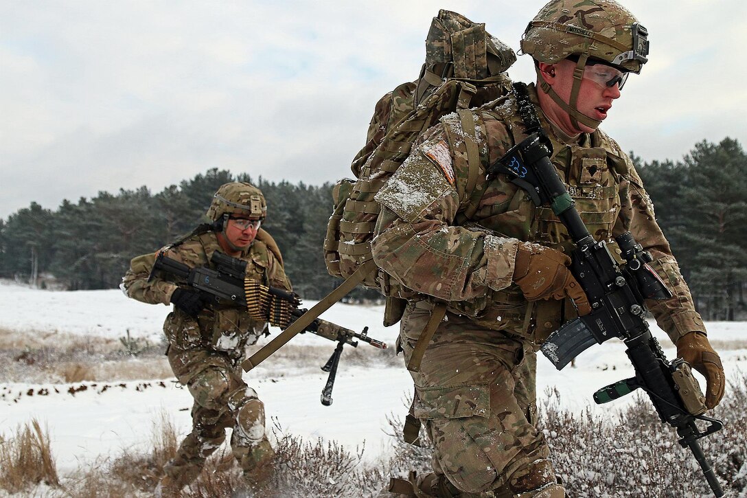 Army Spc. Raymon Najera, left, and Army Spc. Ethan Mitchell advance to their next objective during a live-fire exercise in Konotop, Poland, Jan. 18, 2016. Najera and Mitchell are infantrymen assigned to the 3rd Squadron, 2nd Cavalry Regiment. Army photo by Sgt. Paige Behringer