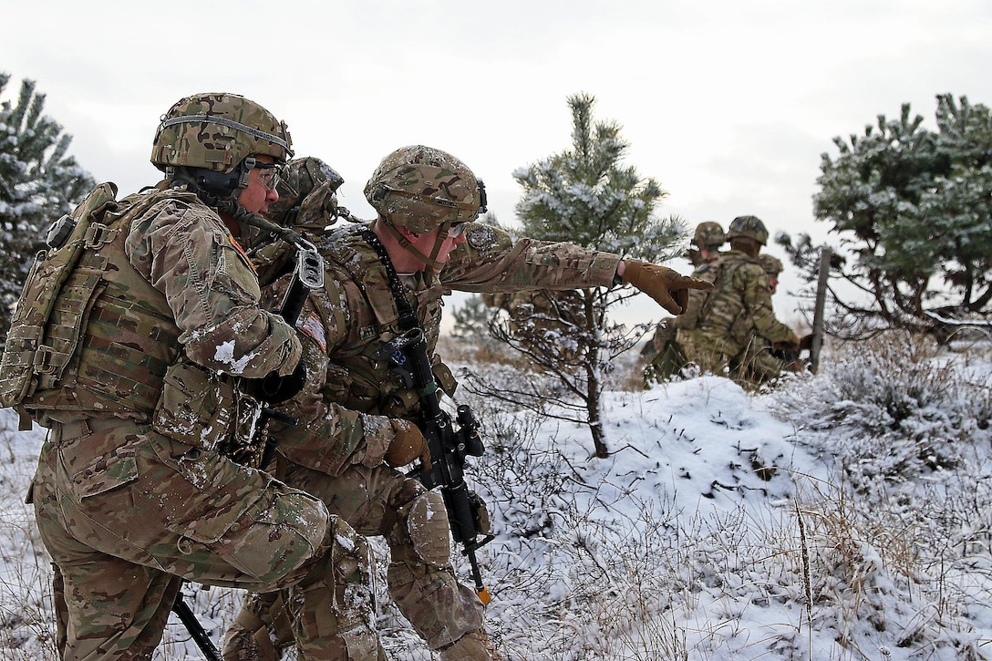 Army Spc. Ethan Mitchell, right, points out the objective location to Army Spc. Raymon Najera during a live-fire exercise in Konotop, Poland, Jan. 18, 2016. Mitchell and Najera are infantrymen assigned to the 3rd Squadron, 2nd Cavalry Regiment. Army photo by Sgt. Paige Behringer