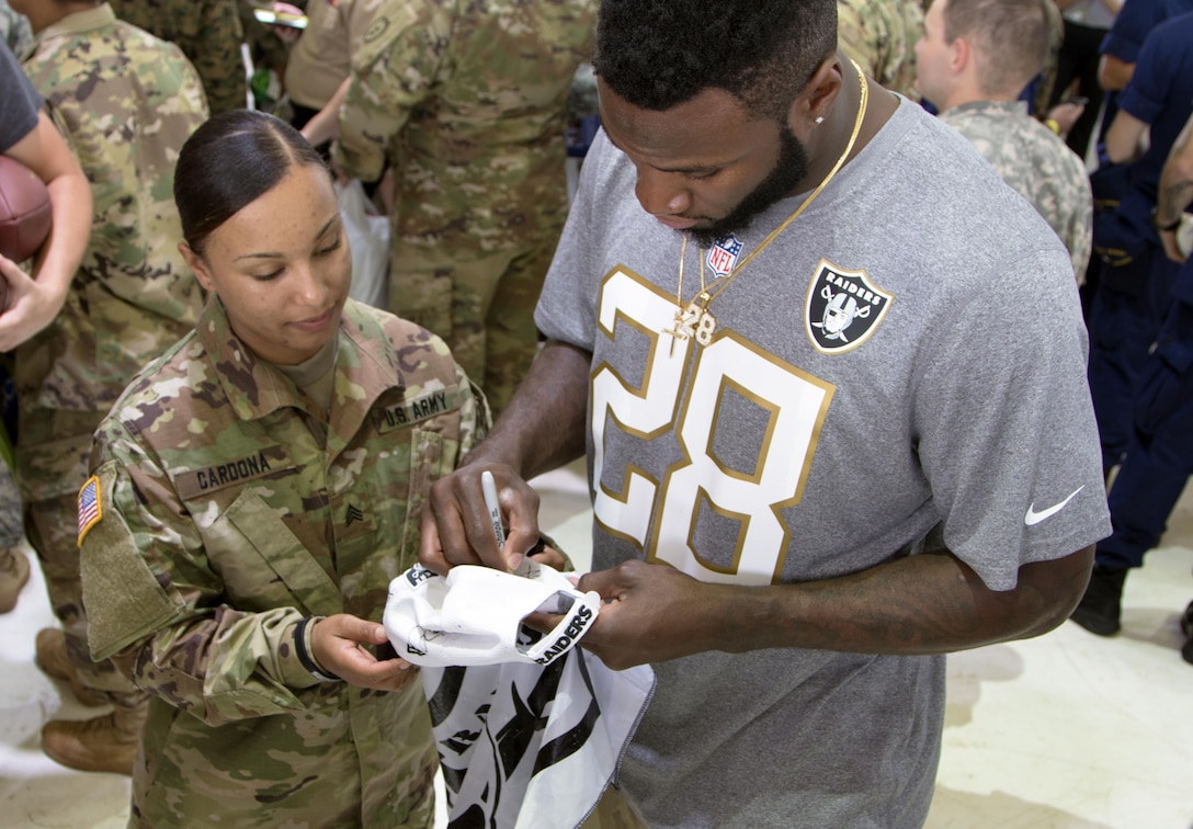 Oakland Raider running back Latavius Murray autographs a hat for a soldier during the 2016 Pro Bowl Draft show on Wheeler Army Airfield, Hawaii, Jan. 27, 2016. U.S. Army photo by Sgt. Kimberly Menzies