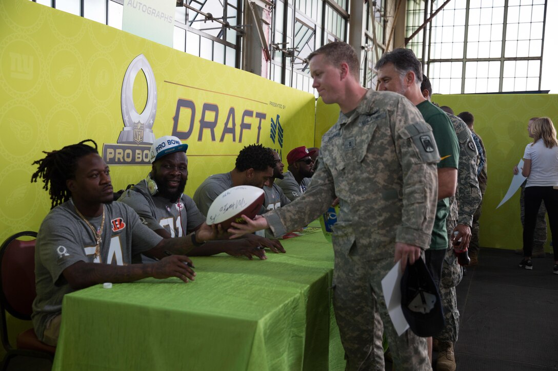Army Chief Warrant Officer 2 Westly Turner has his football signed by multiple NFL stars during the 2016 Pro Bowl Draft on Wheeler Army Airfield, Hawaii, Jan. 27, 2016. Turner is assigned to the 229th Attack Reconnaissance Battalion, U.S. Army photo by Sgt. Daniel K. Johnson
