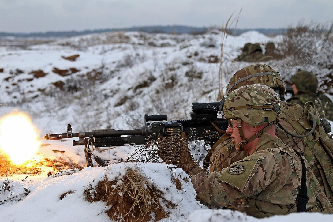 Army Spcs. Ethan Mitchell, foreground, and Raymon Najera fire on their objective with an M240 machine gun during a live-fire exercise in Konotop, Poland, Jan. 18, 2016. Mitchell and Najera are infantrymen assigned to the 3rd Squadron, 2nd Cavalry Regiment. Army photo by Sgt. Paige Behringer