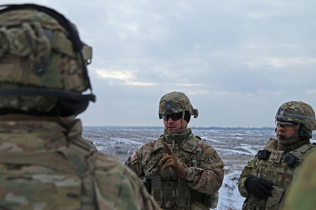 Army Sgt. 1st Class Adam Insco, center, conducts an after-action review with U.S. and Polish soldiers following a live-fire exercise in Konotop, Poland, Jan. 18, 2016. Insco is an infantryman assigned to the 3rd Squadron, 2nd Cavalry Regiment. Army photo by Sgt. Paige Behringer