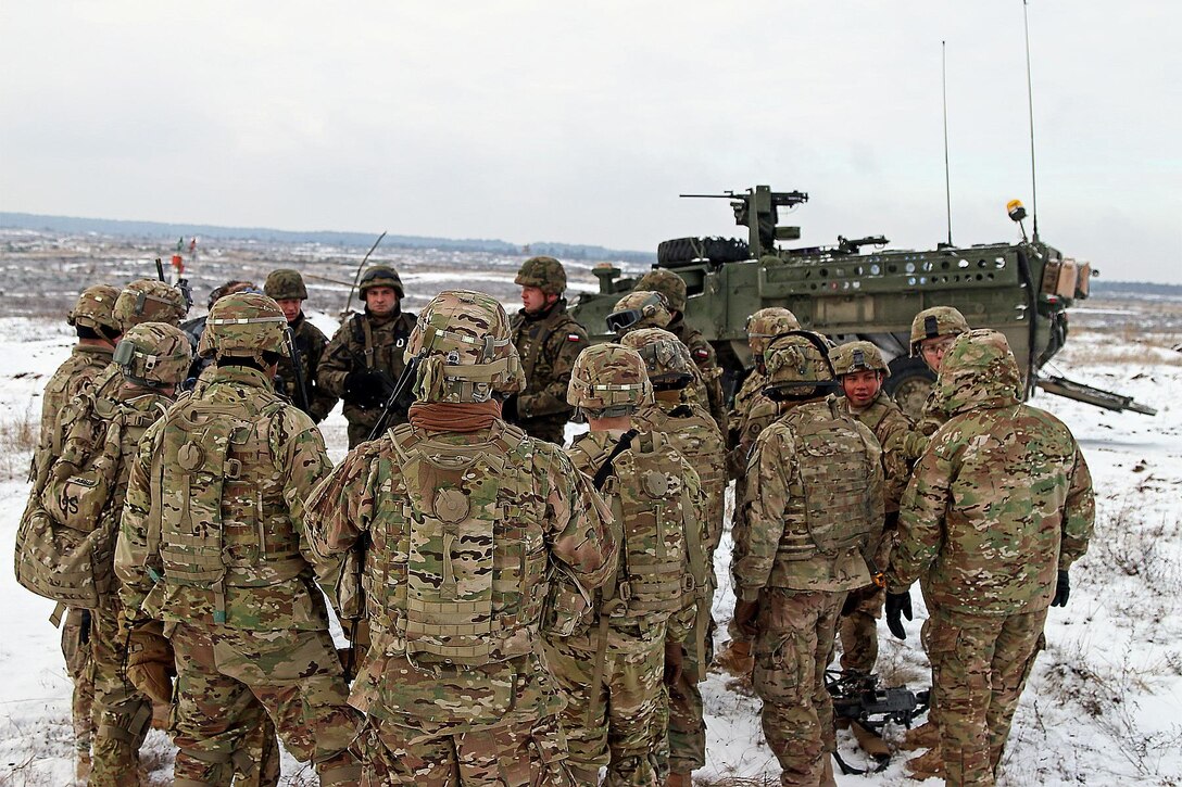 U.S. and Polish soldiers conduct an after-action review following a live-fire exercise in Konotop, Poland, Jan. 18, 2016. Army photo by Sgt. Paige Behringer