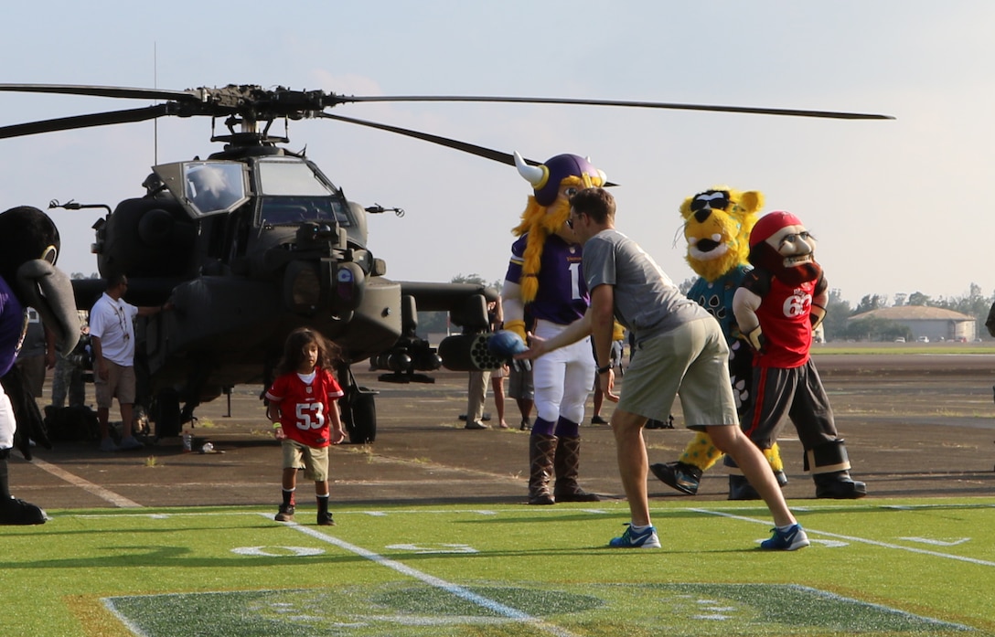 New York Giants quarterback Eli Manning tosses a football to the family member of a soldier during the 2016 Pro Bowl Draft show on Wheeler Army Airfield, Hawaii, Jan. 27, 2016. U.S. Army photo by Sgt. Kimberly Menzies