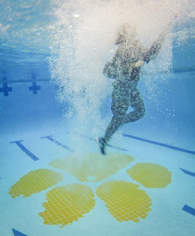 Army ROTC cadet Kerry Carter surfaces after jumping blindfolded into the pool during a combat water survival test on Clemson University, S.C., Jan. 28, 2016. Army photo by Staff Sgt. Ken Scar