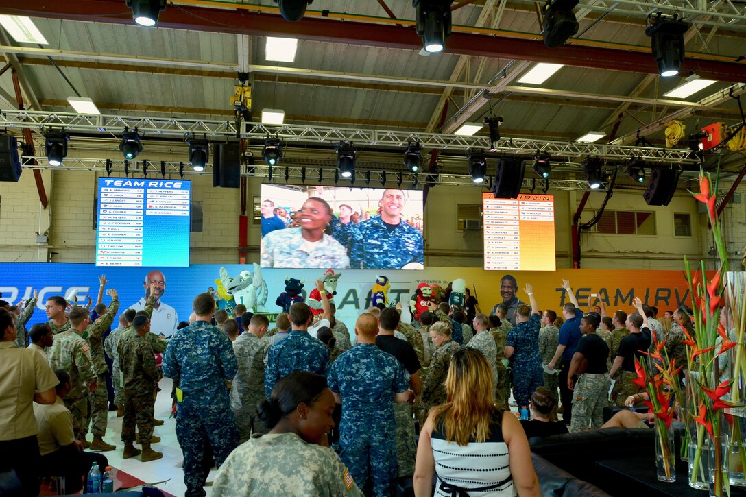 Members of all branches of the U.S. military and their families celebrate the 2016 Pro Bowl Draft with several NFL mascots in an aircraft hanger on Wheeler Army Airfield, Hawaii, Jan. 27, 2016. U.S. Army photo by Sgt. 1st Class John Brown