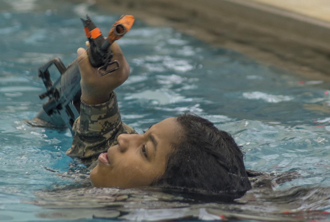Army ROTC cadet Victoria Wilson participates in the 15-meter swim portion of a combat water survival test on Clemson University, S.C., Jan. 28, 2016. Participants must swim 15 meters in uniform carrying an M16 rifle without touching the bottom or sides of the pool. Army photo by Staff Sgt. Ken Scar