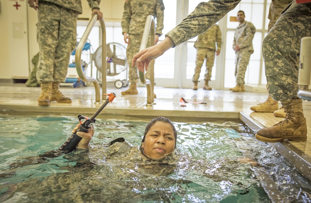 Army ROTC cadet Victoria Wilson completes the 15-meter swim portion of a combat water survival test on Clemson University, S.C., Jan. 28, 2016. Army photo by Staff Sgt. Ken Scar