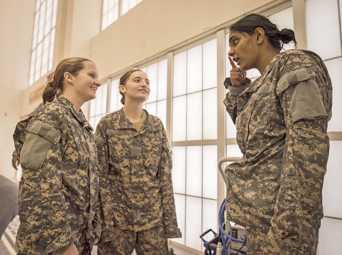 Army ROTC cadet Preksha Jayamarughyraman, right, shares a moment with two other female cadets after completing the “equipment drop” portion of a combat water survival test on Clemson University, S.C., Jan. 28, 2016. Army photo by Staff Sgt. Ken Scar