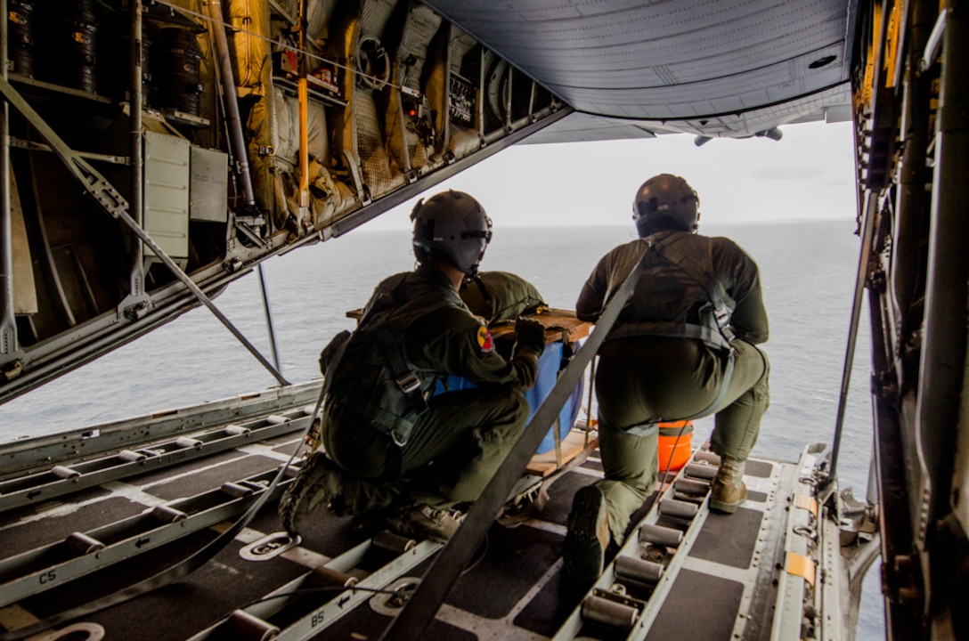 Air Force Tech. Sgt. Cole Temmen and Senior Airman Justin Mays prepare to conduct an airdrop off the coast of Key West, Fla., Jan. 22, 2016. Temmen and Mays are loadmasters assigned to the Missouri Air National Guard’s139th Airlift Wing. Missouri Air National Guard photo by Senior Airman Sheldon Thompson