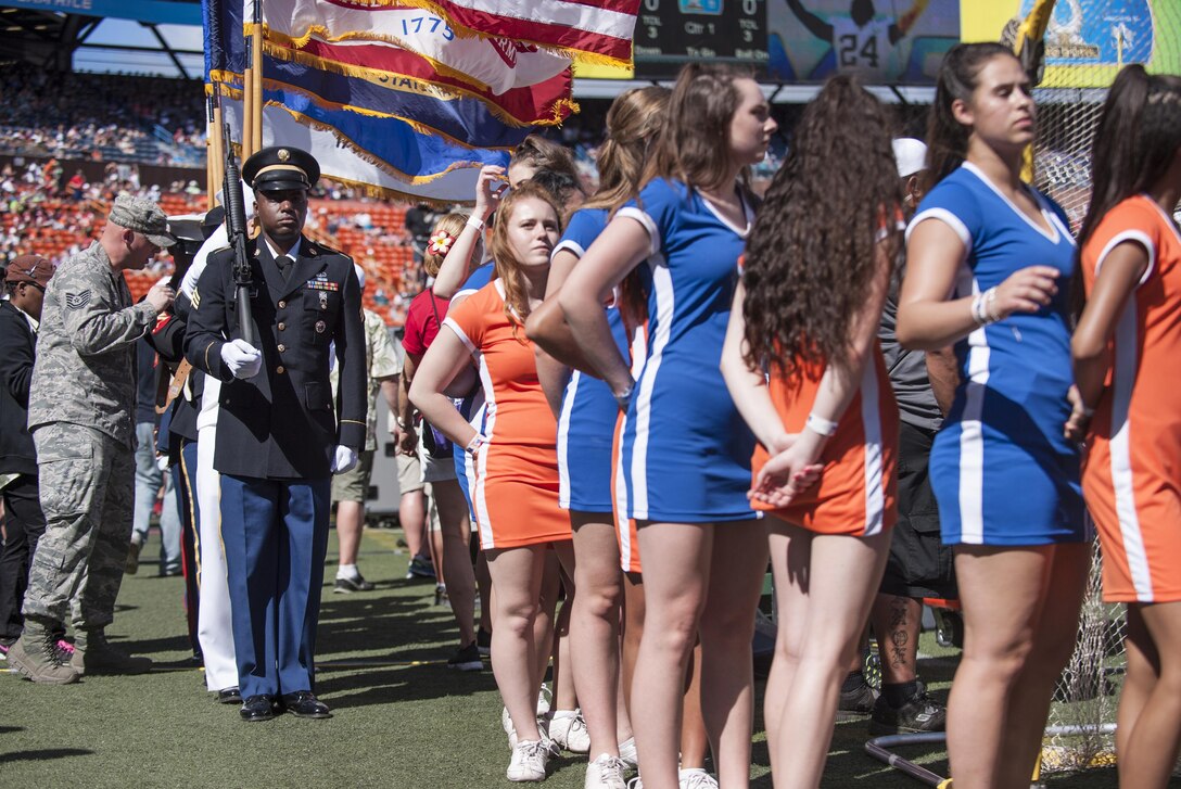 A joint honor guard detail prepares to render honors during the 2016 NFL Pro Bowl as part of the event’s pregame show at Aloha Stadium in Honolulu, Jan. 31, 2016. More than 200 military volunteers worked together to construct the pregame show stage in support of Rachel Platten’s performance of her song “Fight Song.” The U.S. military also conducted a C-17 Globemaster flyover and U.S. Pacific Command leadership participated in the game’s coin toss. DoD photo by Staff Sgt. Christopher Hubenthal