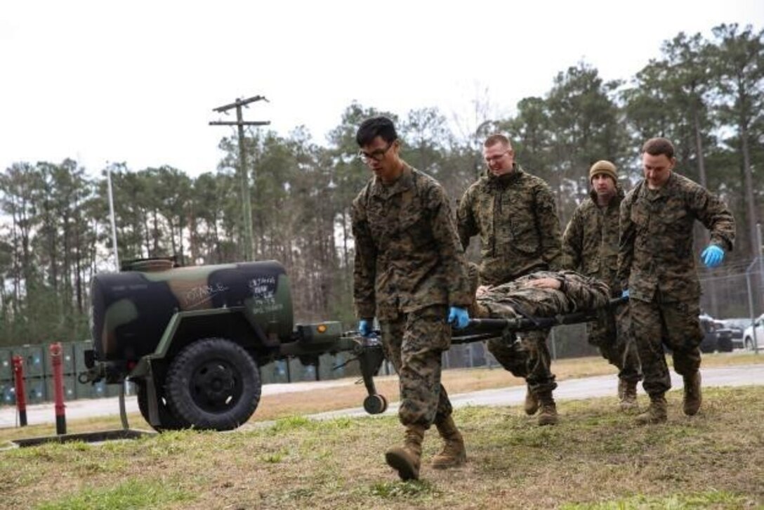 Corpsmen with 2nd Medical Battalion rush role-playing patients into a medical tent at Camp Lejeune, N.C, Jan. 28, 2016.  The training is preparing a Shock Trauma Squad to treat cold related injuries for an upcoming multinational exercise, Cold Response 16.1, in Norway.  (U.S. Marine Corps photo by Cpl. Michael Dye/Released)